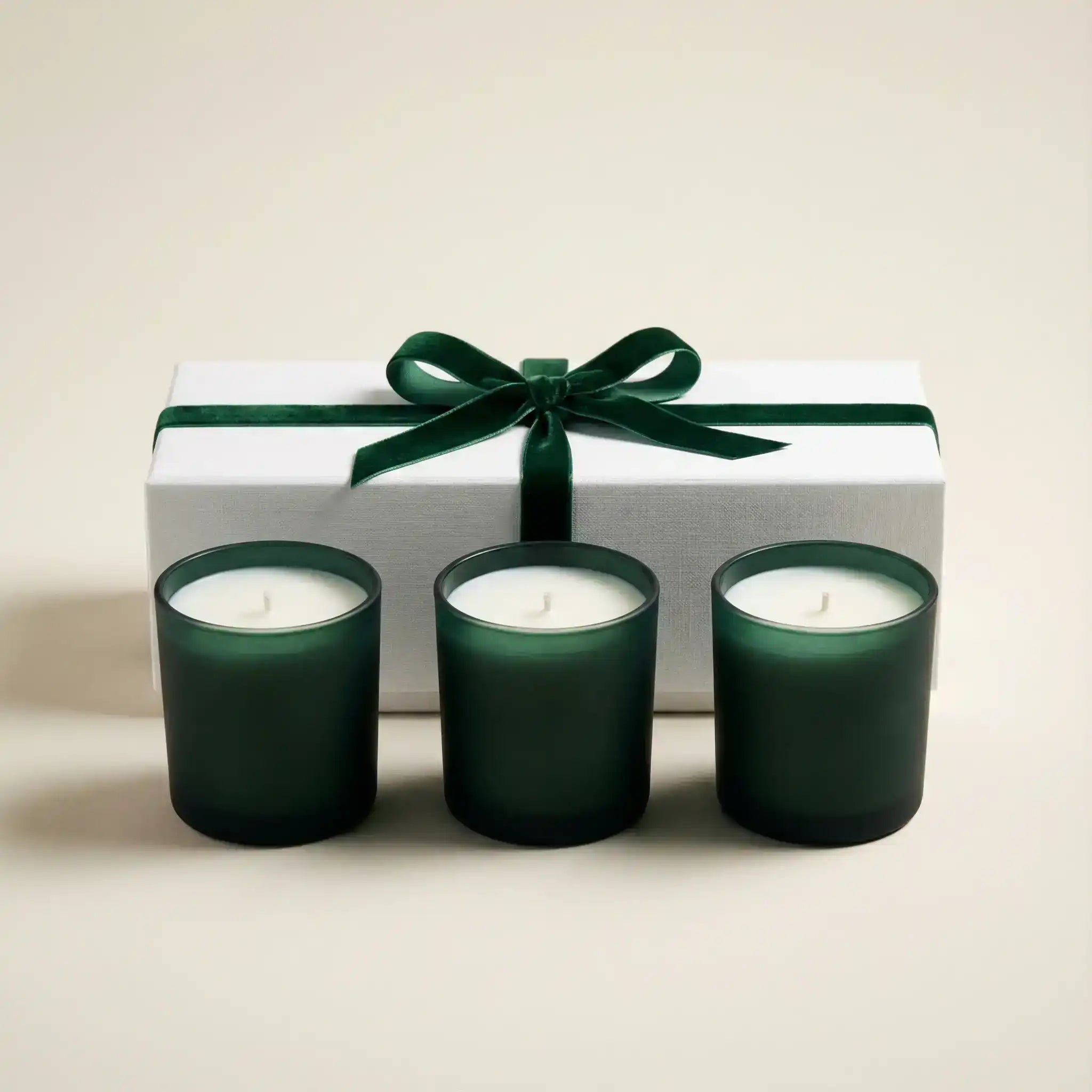 AEMBR non-toxic candles in green glass jars with a gift box tied with a velvet green ribbon