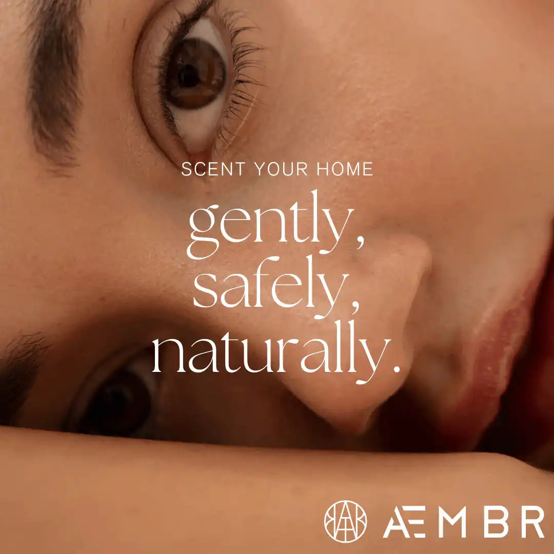 Close-up of a relaxed face with text promoting AEMBR non-toxic home scents and logo visible.