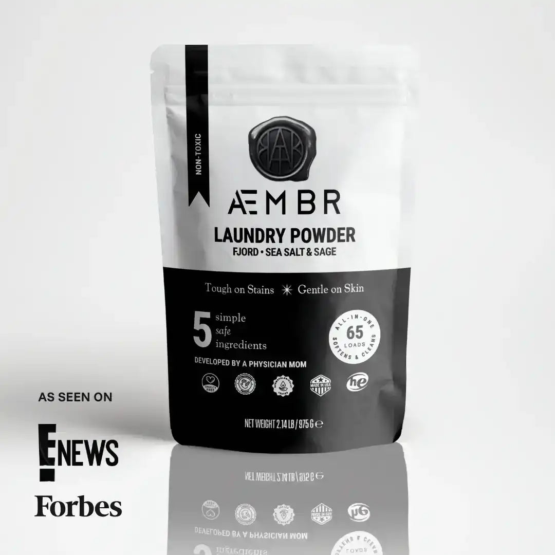 AEMBR non-toxic laundry powder pouch with branding, eco-friendly badges, and 'As Seen On E! News, Forbes'