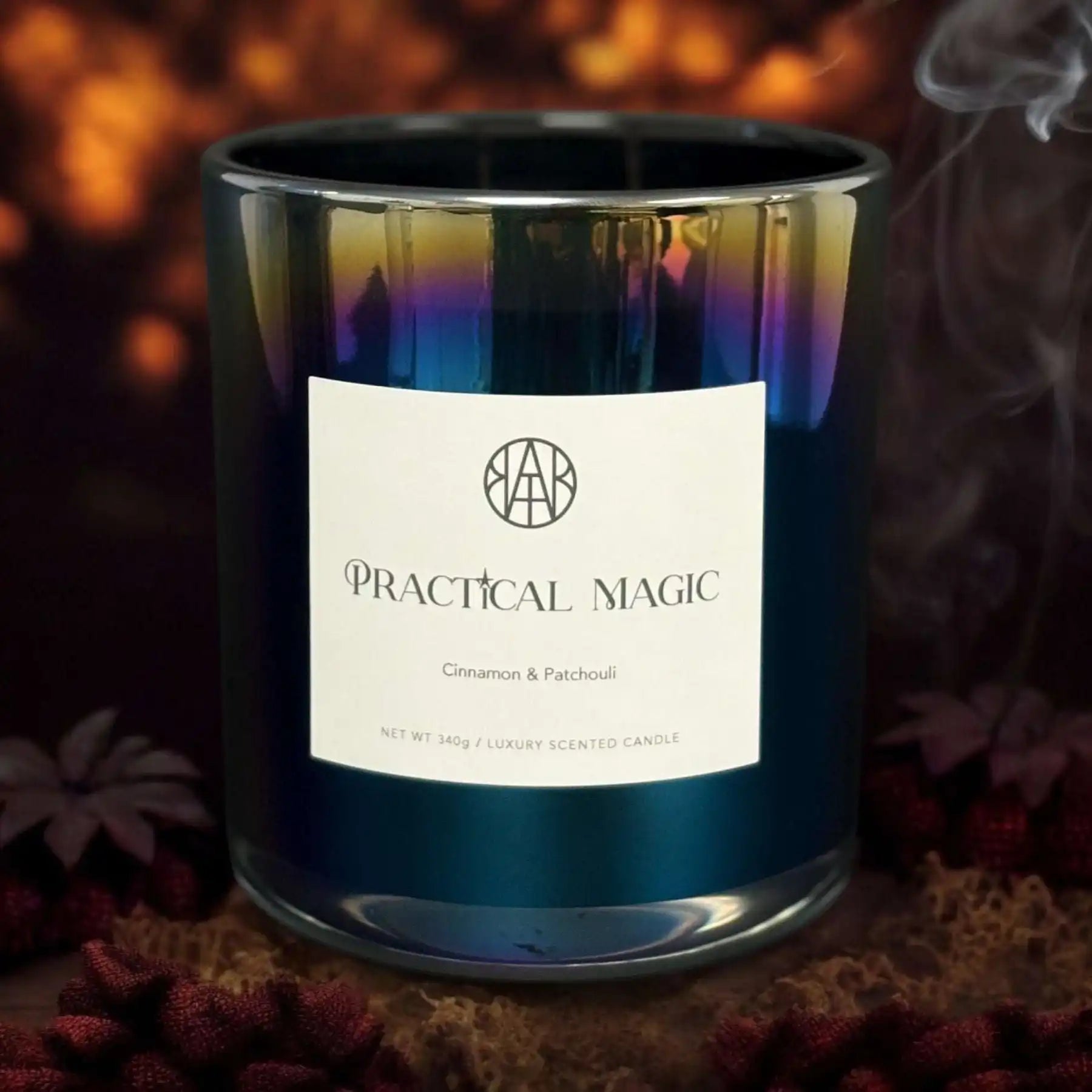 AEMBR Practical Magic cinnamon and patchouli luxury candle in iridescent glass, moody backdrop