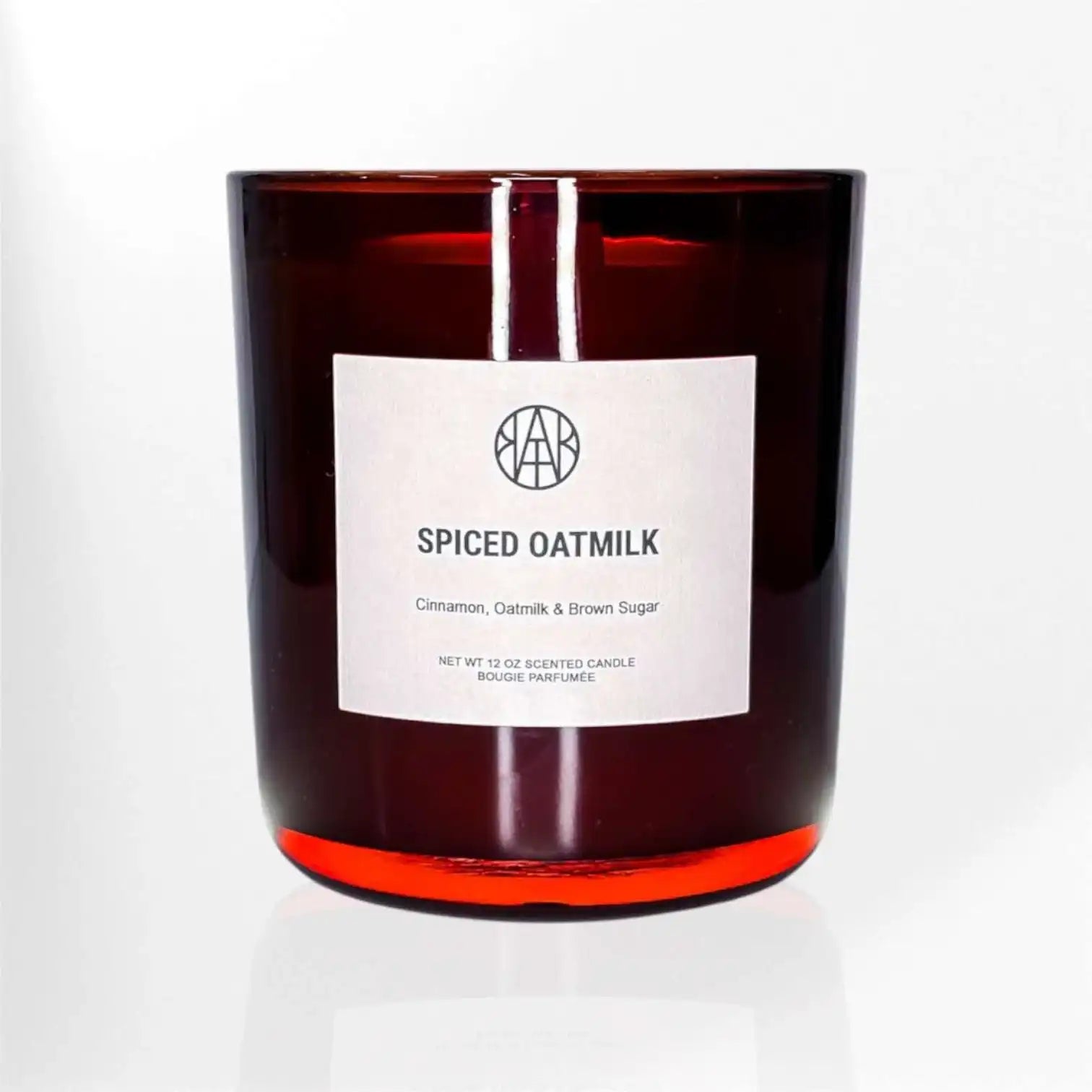AEMBR Spiced Oatmilk scented candle in a brown glass jar with minimalist label
