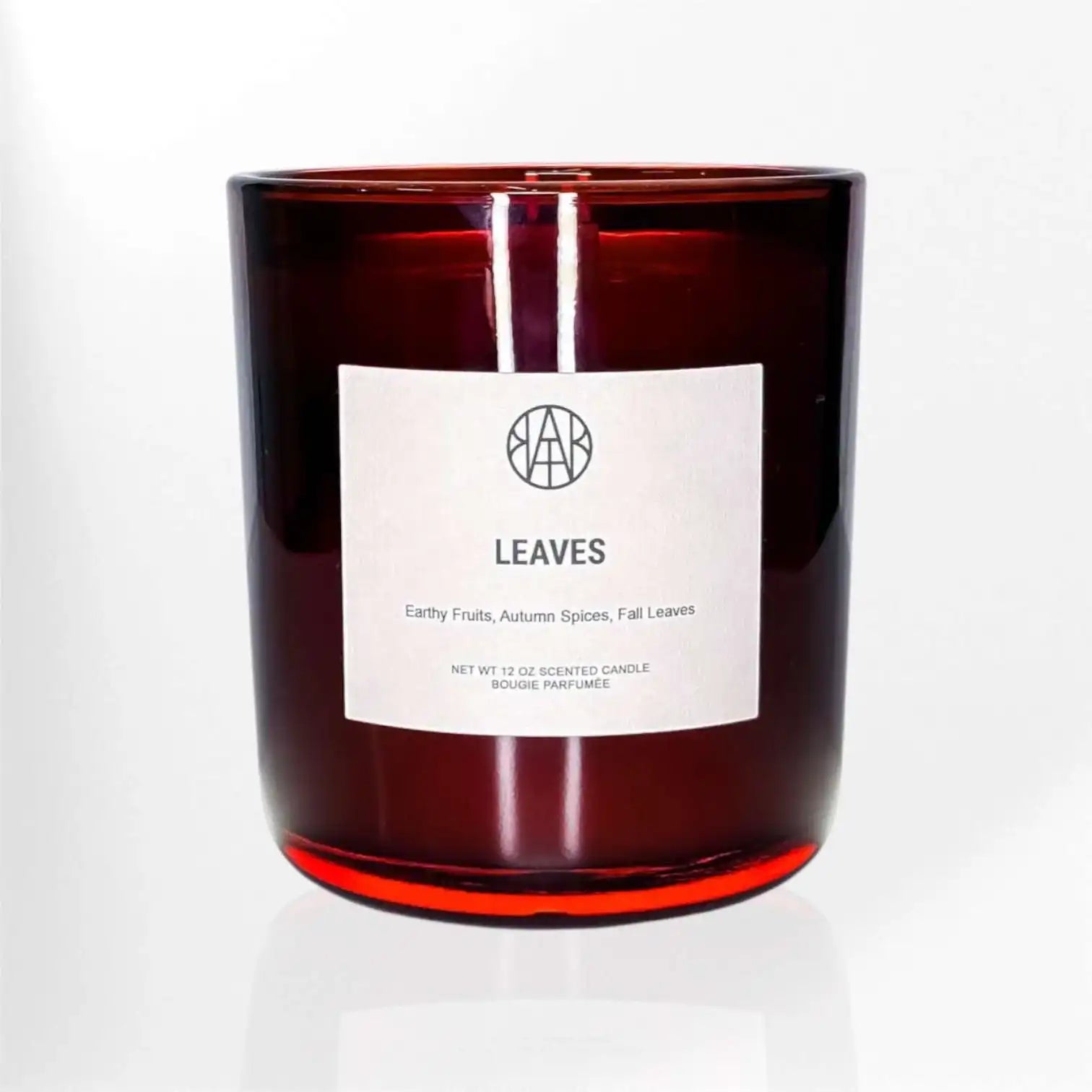 AEMBR Leaves scented candle in a red glass jar with minimalist label, non-toxic home fragrance.