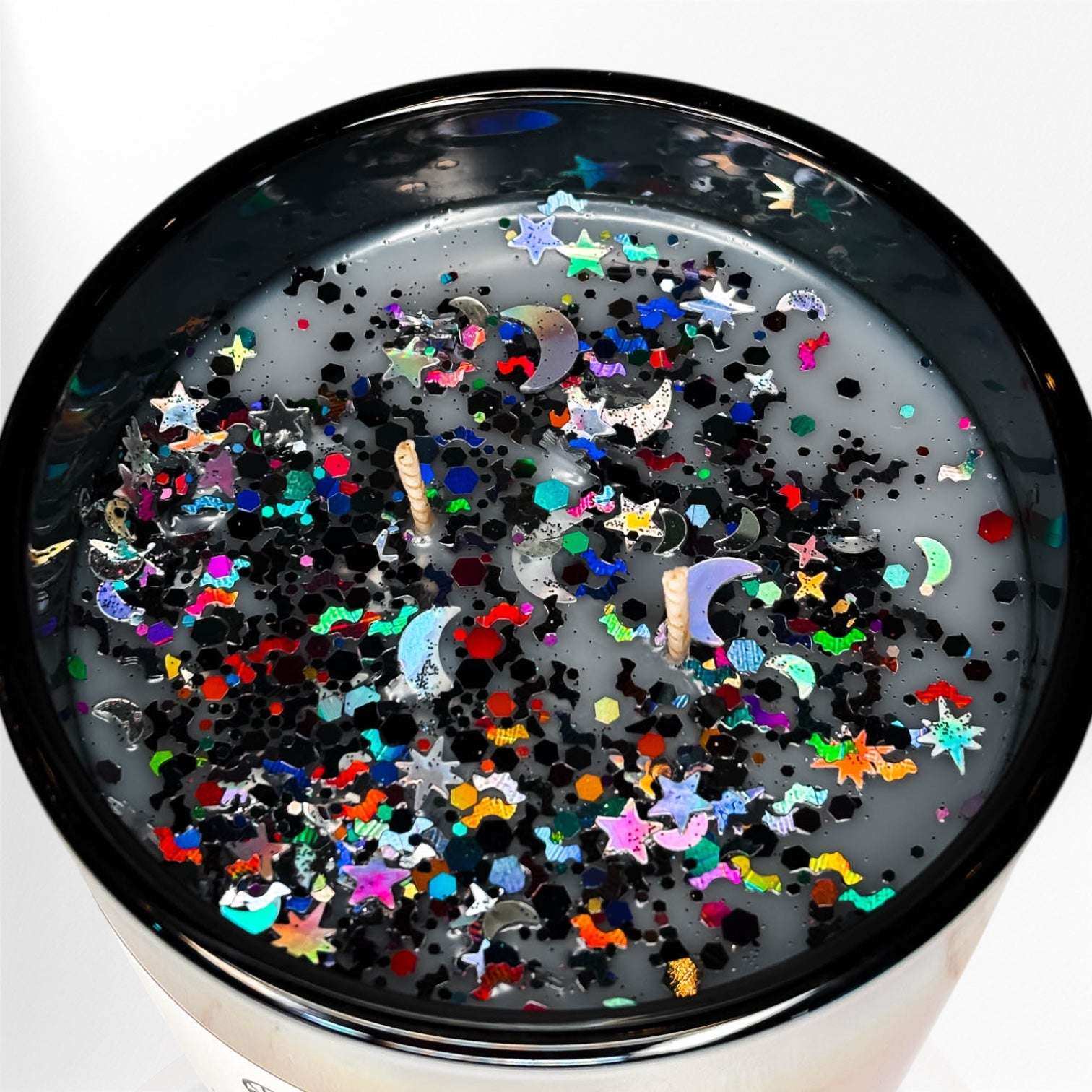 AEMBR non-toxic candle with colorful glitter, stars, and moons on the wax surface