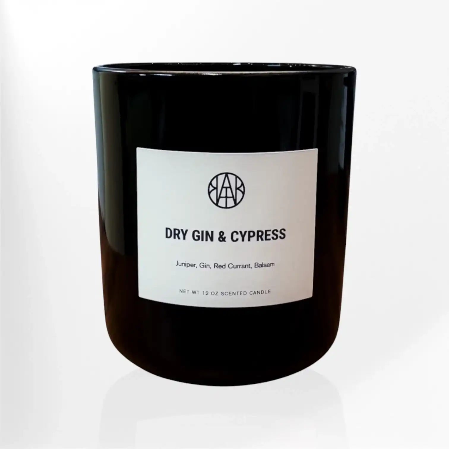 AEMBR Dry Gin & Cypress scented candle in black glass jar on white background.