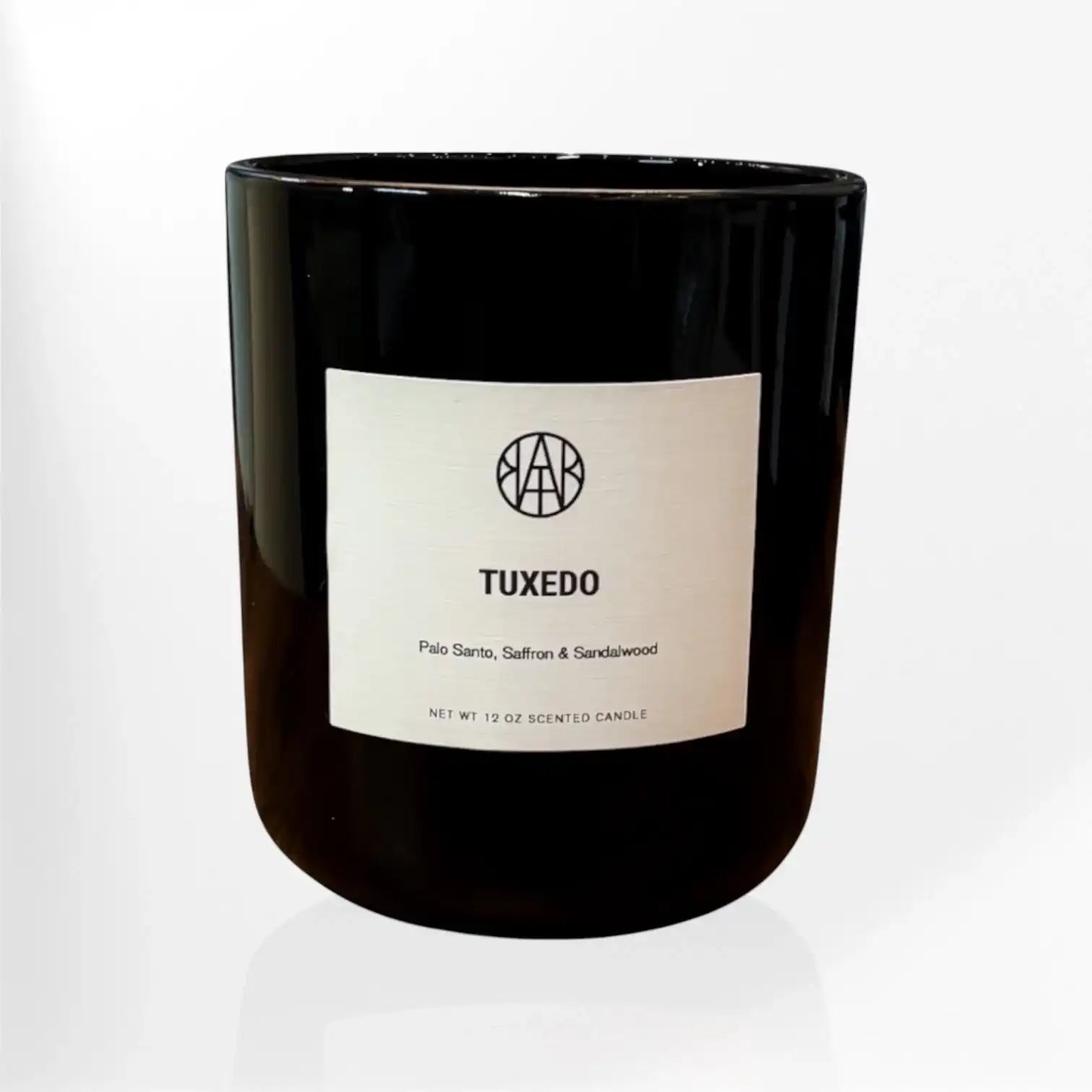 AEMBR Tuxedo black glass candle with palo santo, saffron, and sandalwood label on white background