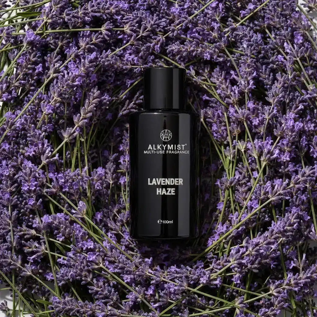 Non-toxic Lavender Haze multi-use fragrance bottle surrounded by fresh lavender flowers