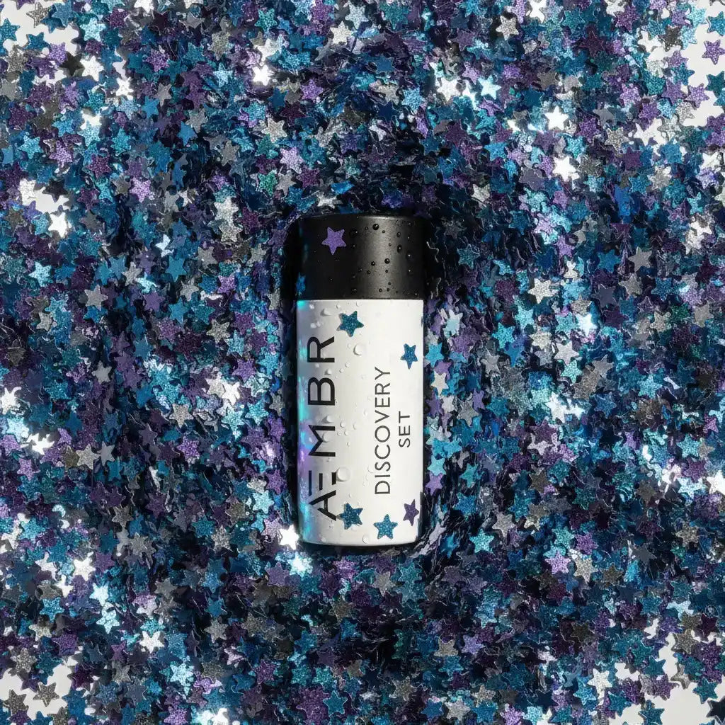 AEMBR Discovery Set bottle on metallic blue and silver star confetti, non-toxic home product
