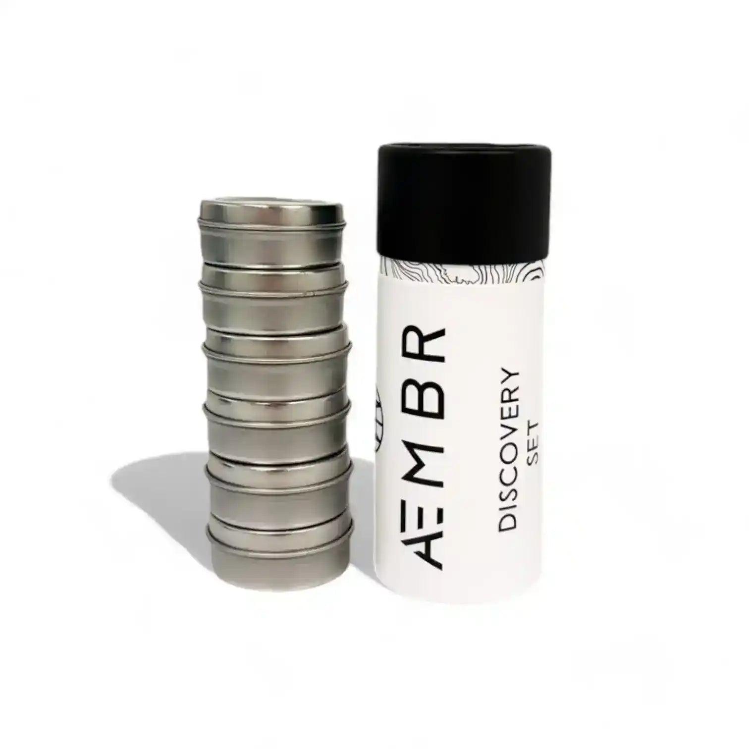 AEMBR Discovery Set of candles with various scents in elegant glass containers, displayed on a neutral surface.