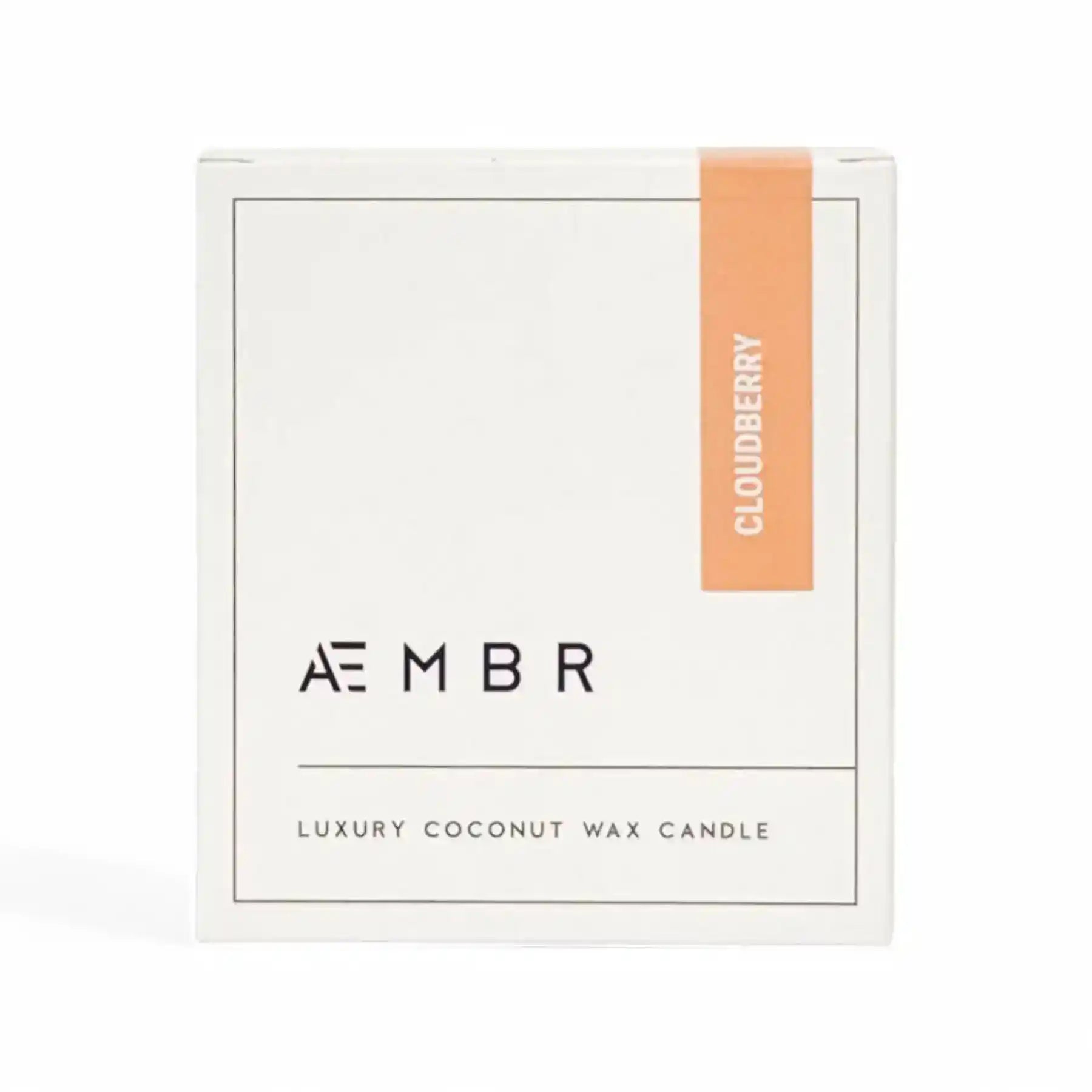 AEMBR Cloudberry Candle with a glass jar and label, showcasing its warm, inviting glow and natural aesthetic.