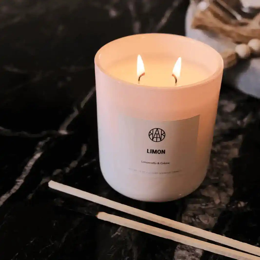 AEMBR Limon Candle with fresh lemon scent, featuring a white wax candle in a clear glass jar, perfect for home decor and ambiance.