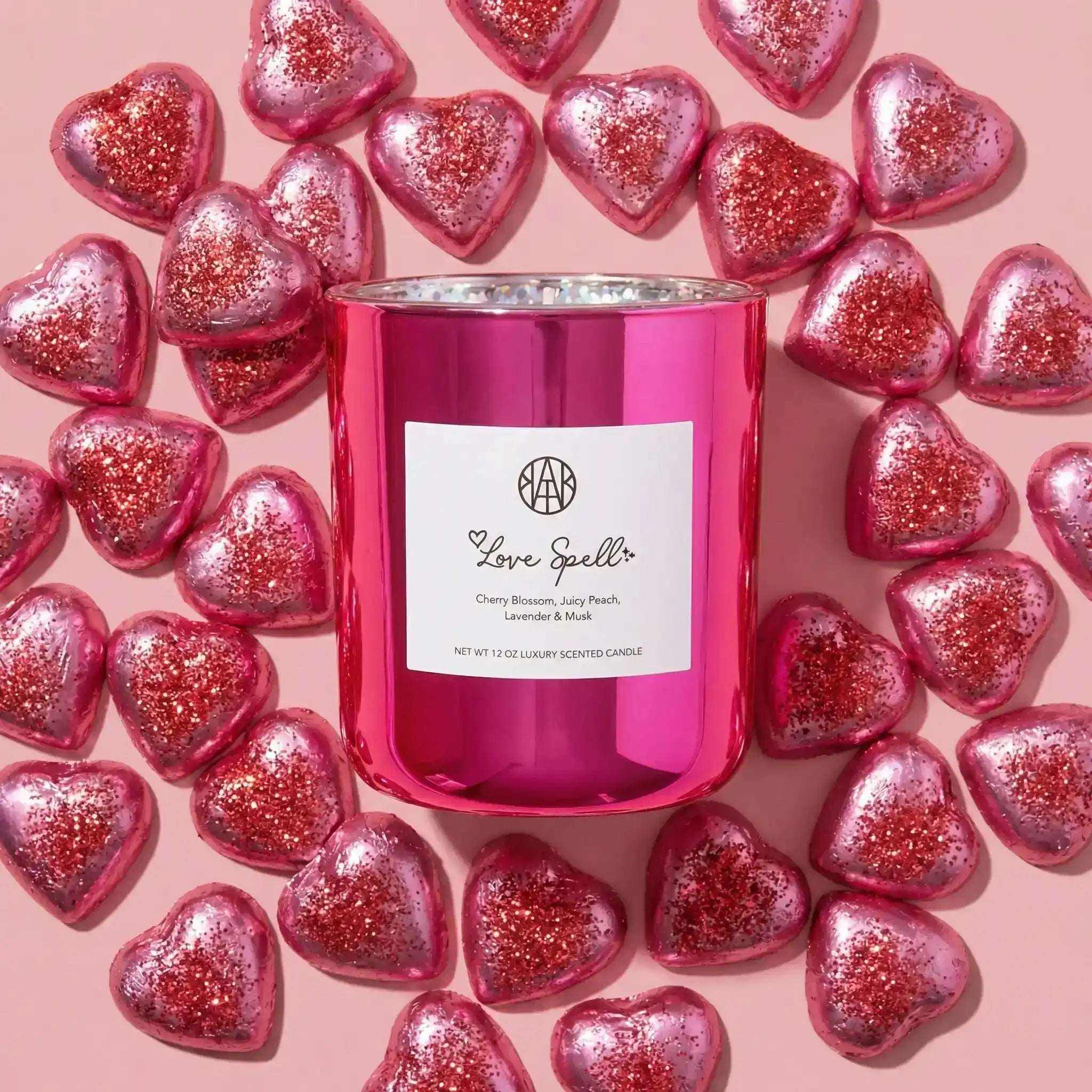 AEMBR Love Spell Candle with a decorative glass holder, featuring a pink and purple label design for romantic ambiance.