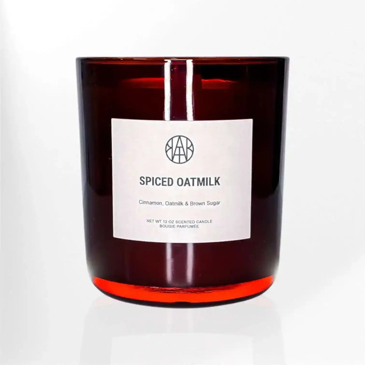 AEMBR Spiced Oatmilk Candle with a simple glass jar and cozy, warm-toned candle wax ready to burn.