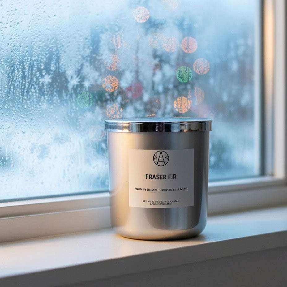 AEMBR Fraser Fir candles in Silver & Gold Editions with festive green and metallic accents, perfect for holiday decor.