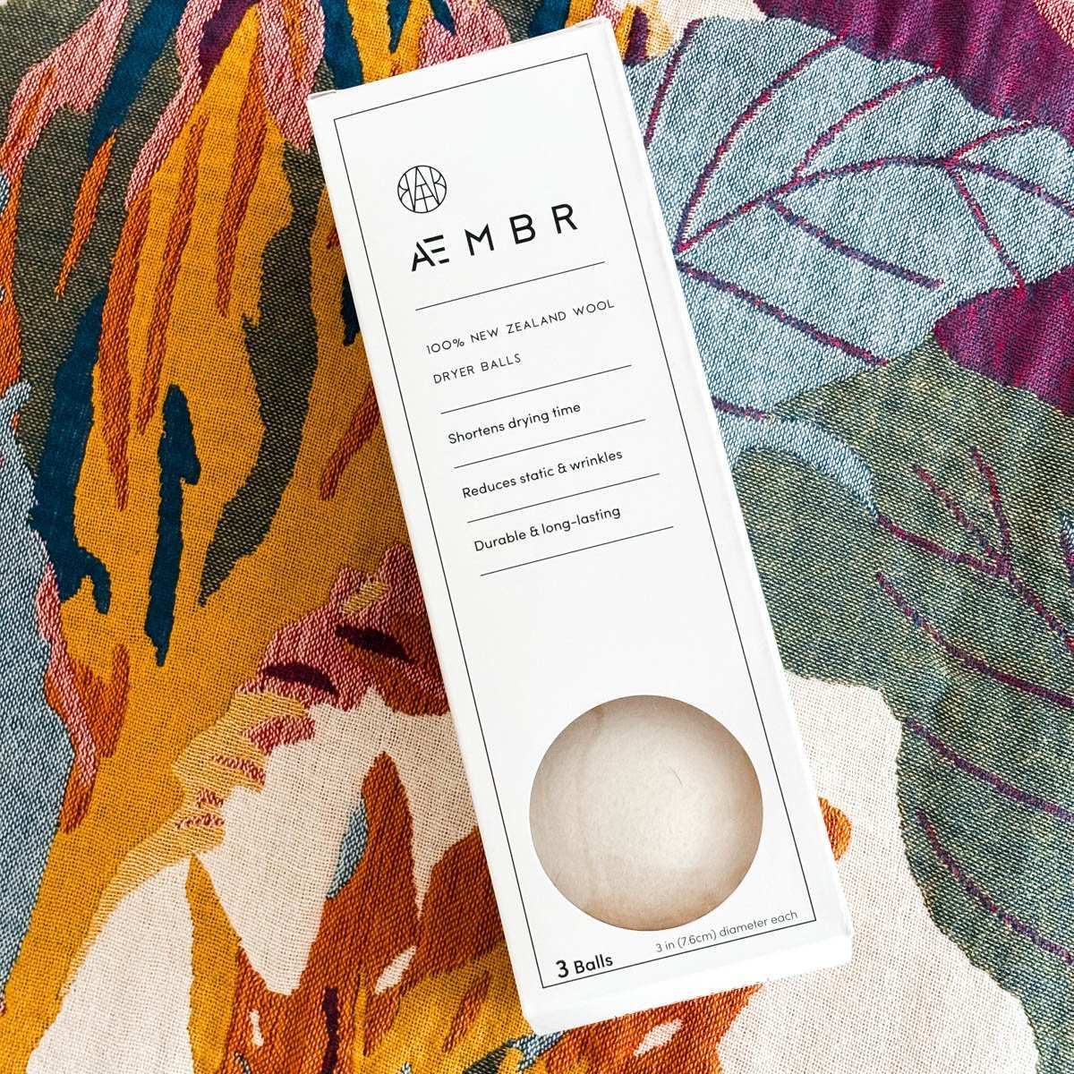 AEMBR 100% New Zealand wool dryer balls box on colorful floral fabric background
