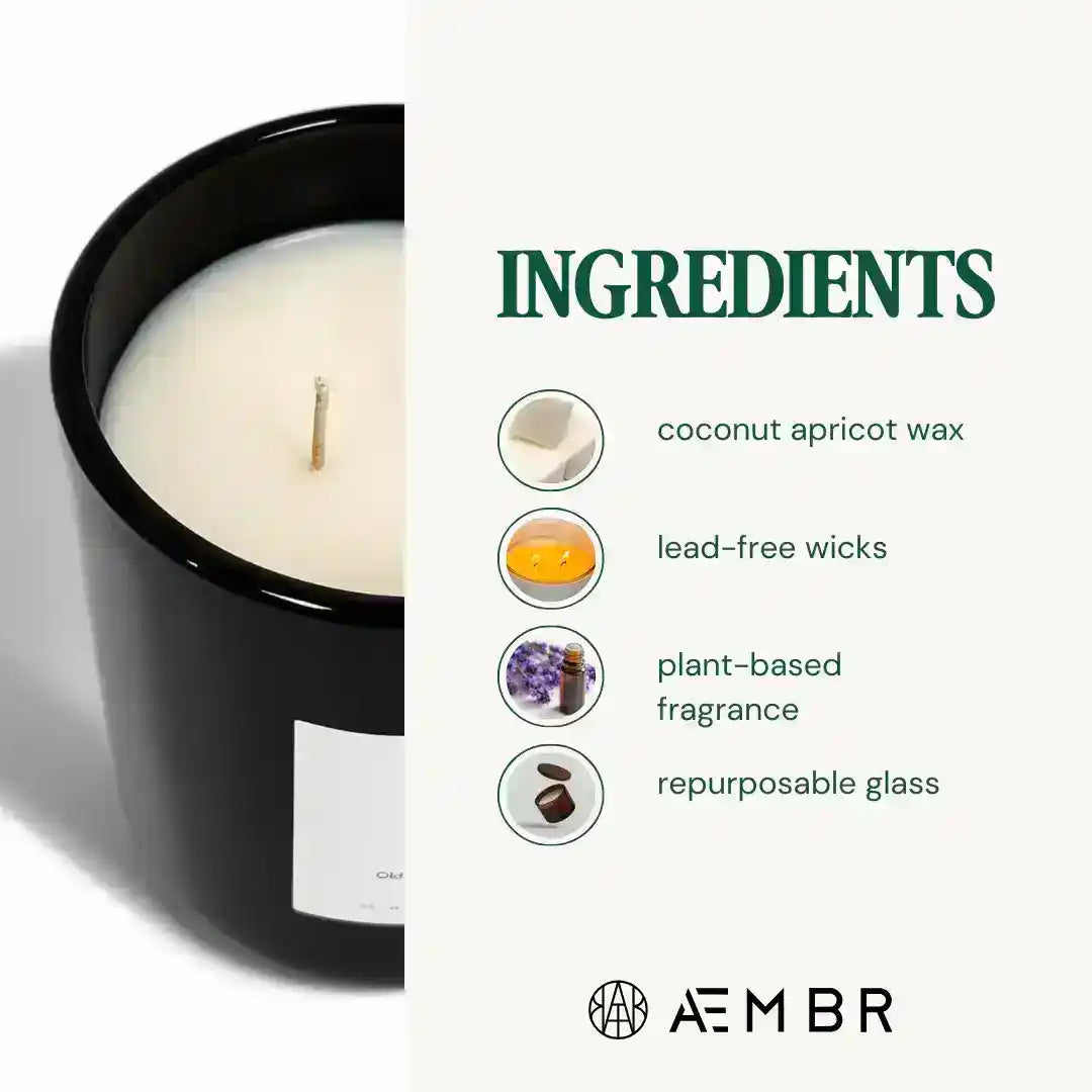 AEMBR The Manifest Candle with soothing scent, displayed alongside laundry care products in a cozy, modern setting.