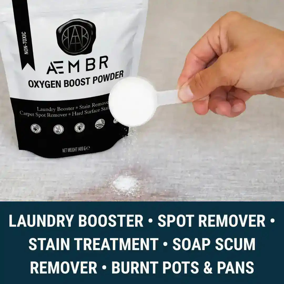 AEMBR Oxygen Boost laundry additive in a clear container with a scoop, part of the Fjord laundry bundle with dryer balls and linen spray.