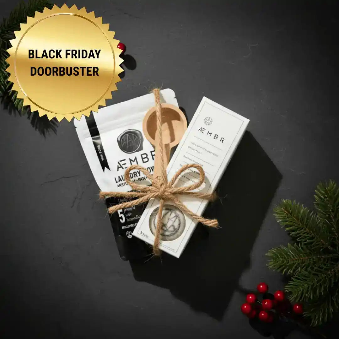 AEMBR luxury laundry gift set with sea salt, sage, blonde woods scent, including detergent and fabric softener bottles.