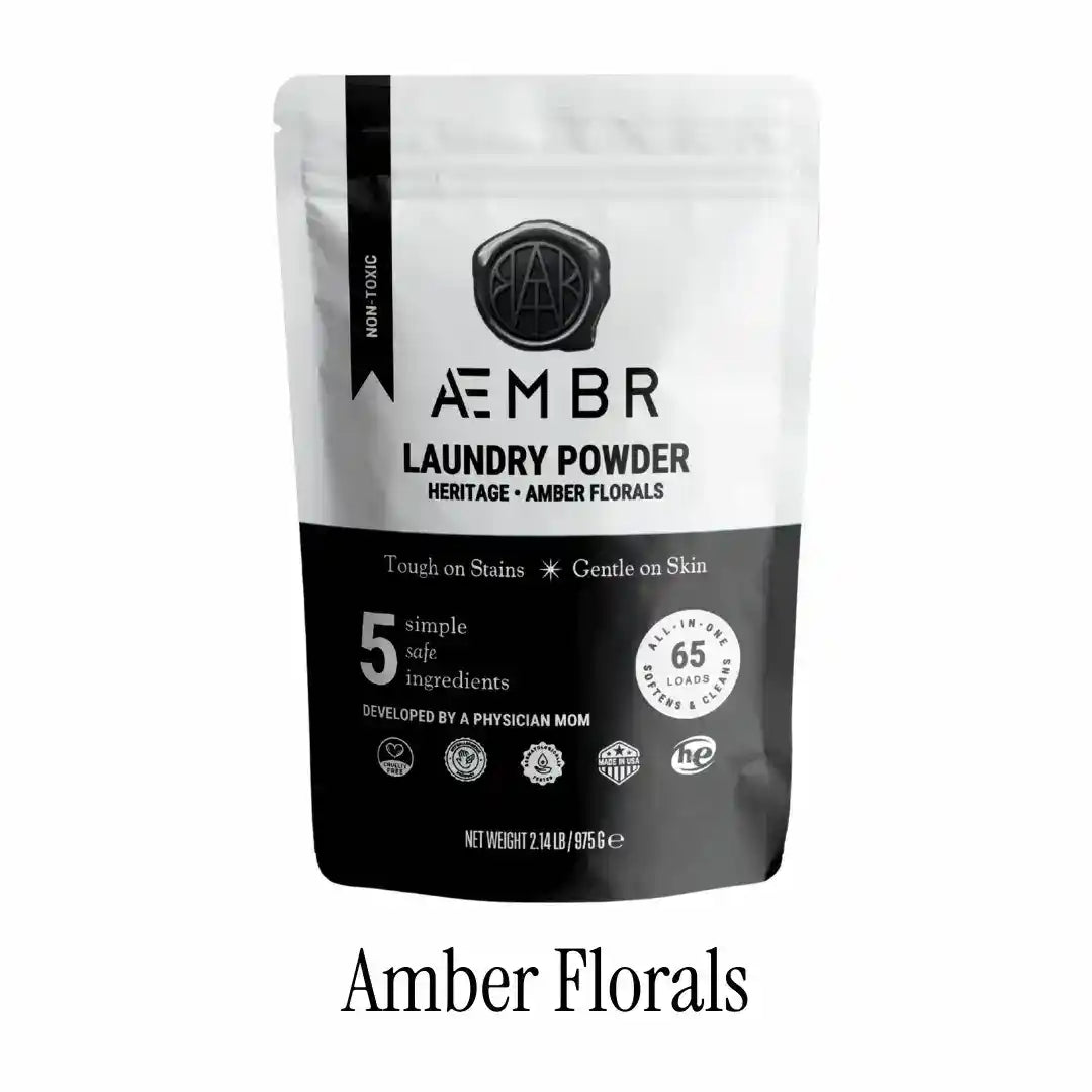 Non-toxic laundry detergent powder amber florals scent in resealable black and white bag, 65 loads