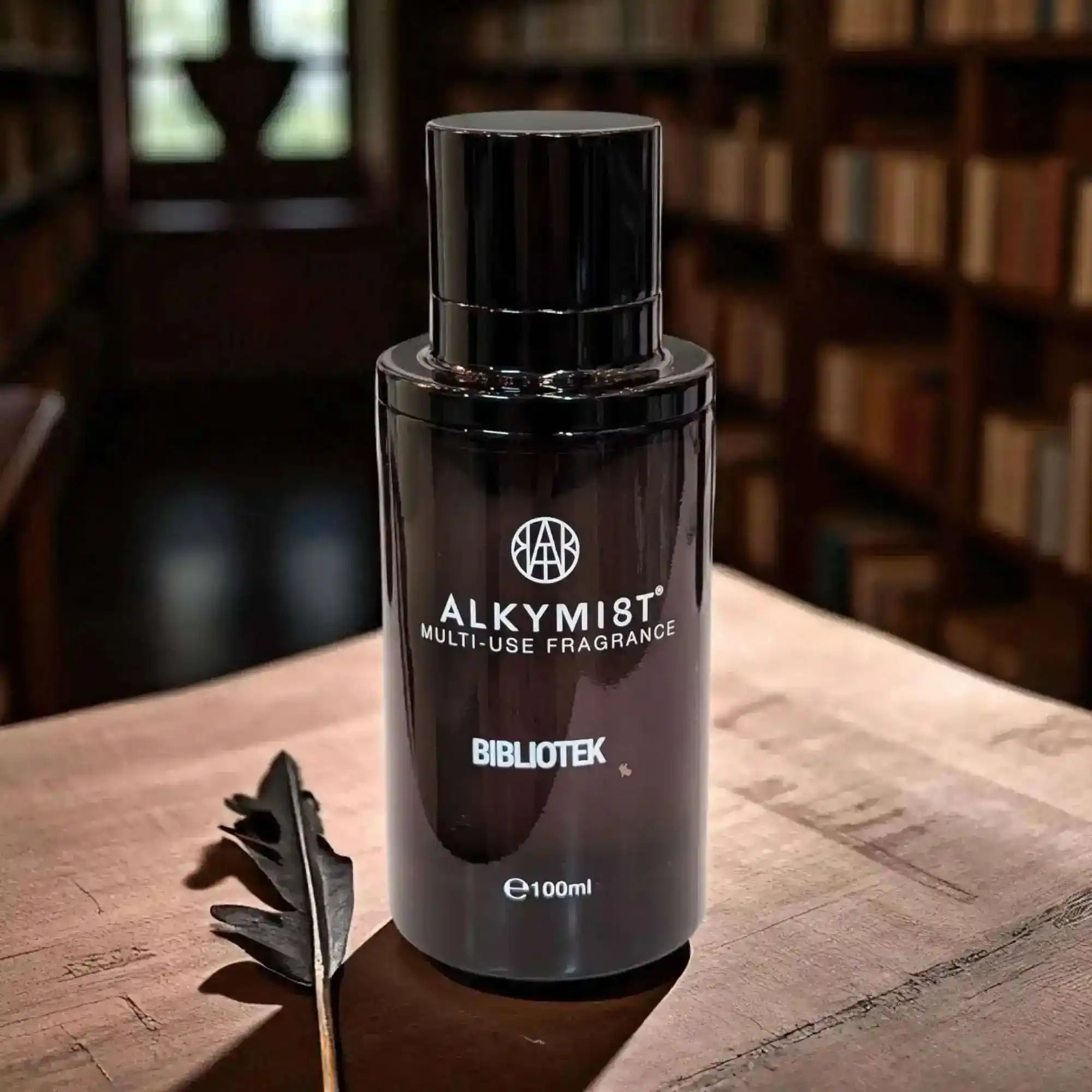 AEMBR ALKYMIST® Luxe Bibliotek multi-use fragrance bottle with elegant packaging and spray nozzle.