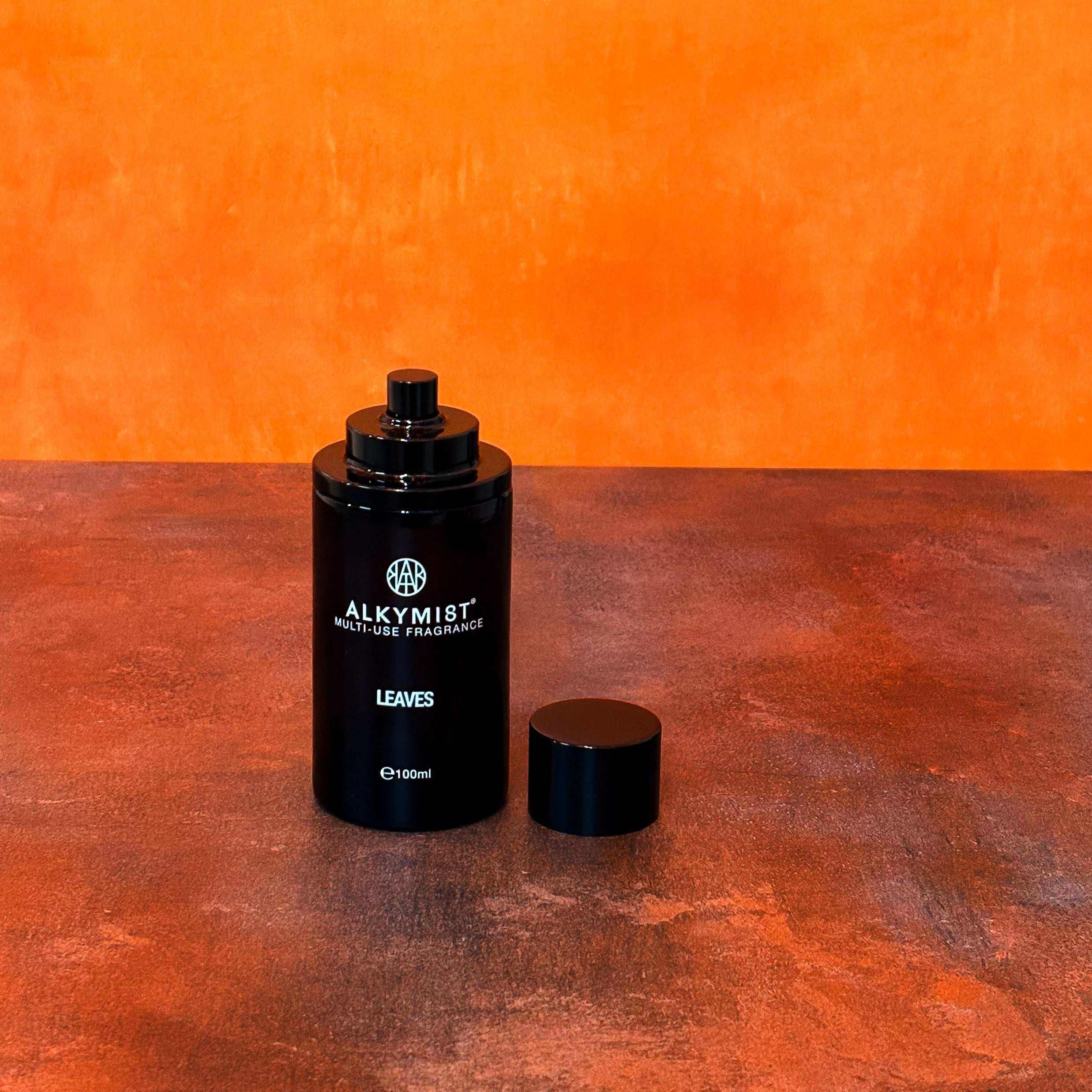 AEMBR ALKYMIST® Luxe Leaves multi-use fragrance bottle with elegant packaging and green leaf design.