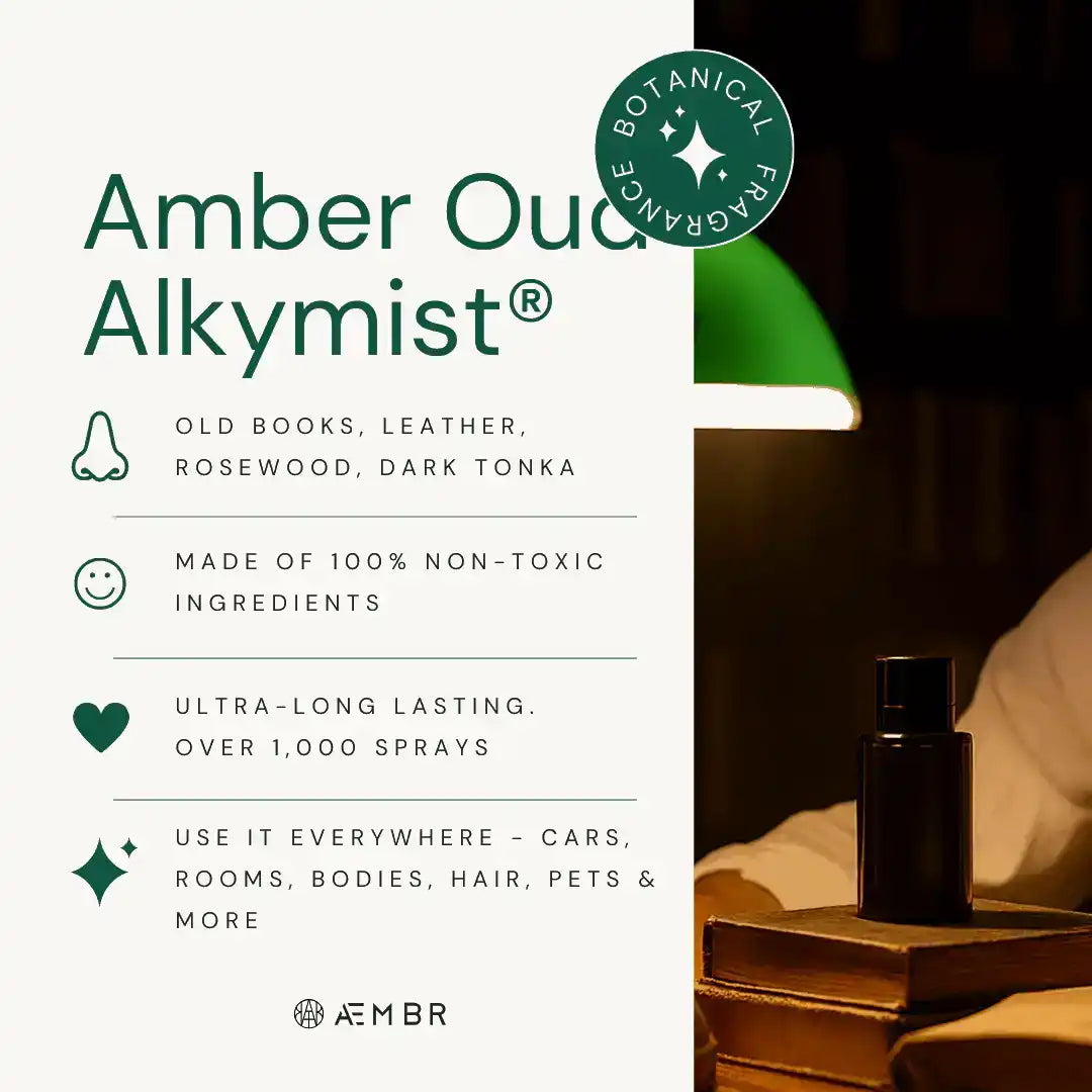 Amber Oud Alkymist non-toxic spray bottle on books under green lamp, botanical fragrance