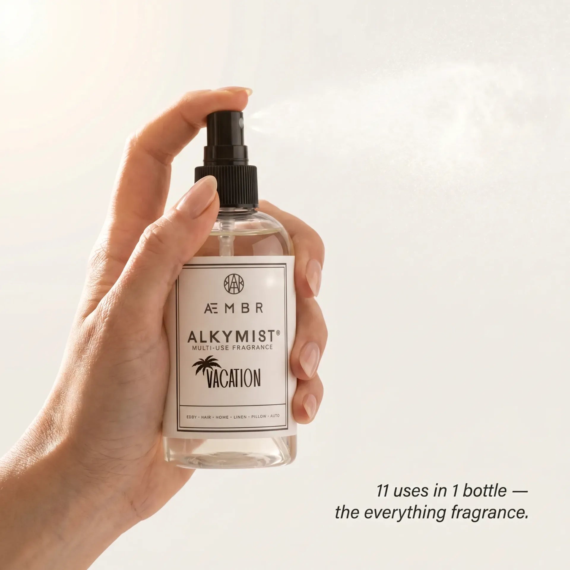 AEMBR ALKYMIST Vacation being sprayed — 11 uses in 1 bottle, skin-safe flame-free formula, non-toxic luxury fragrance mist