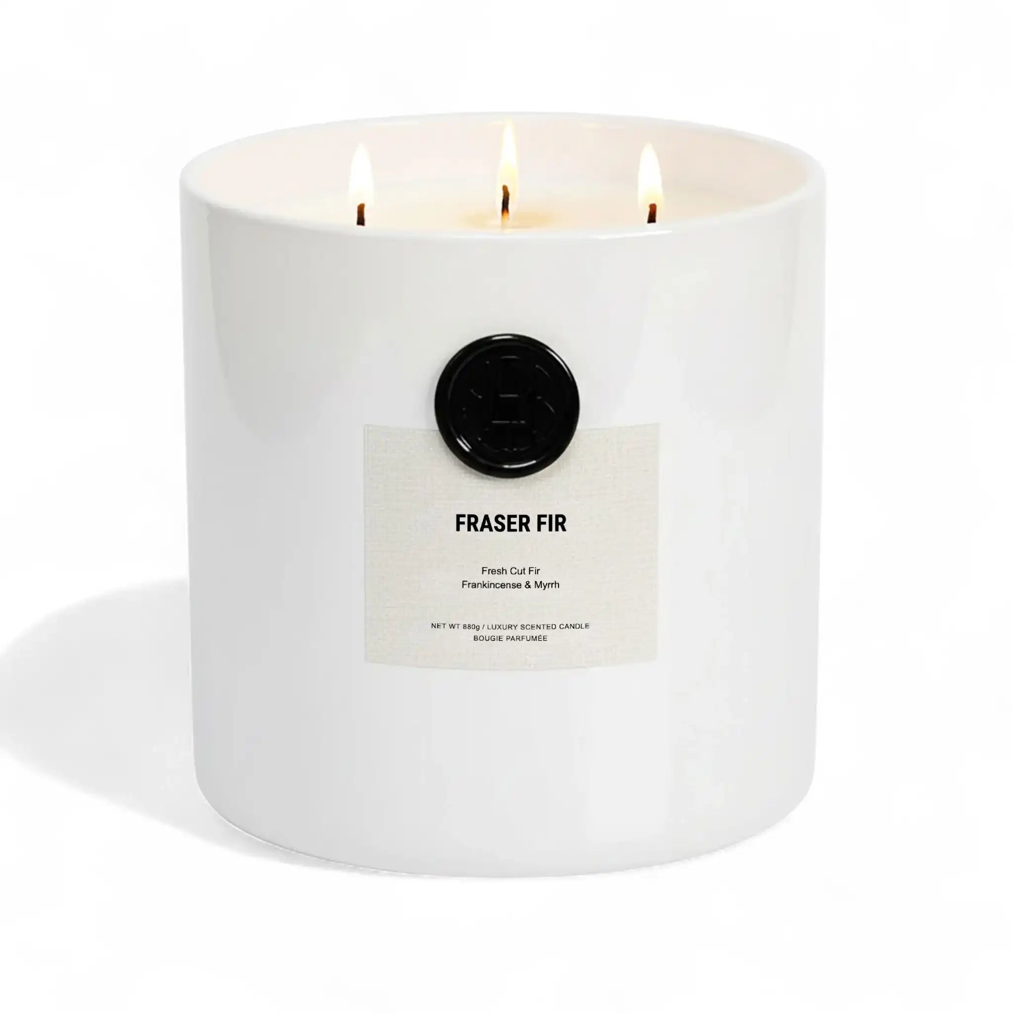 AEMBR Fraser Fir luxury scented candle in white jar with three lit wicks on white background
