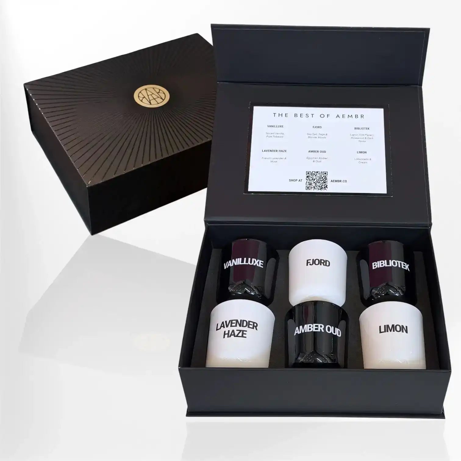 AEMBR luxury gift box with six assorted non-toxic scented candles displayed in open black packaging.