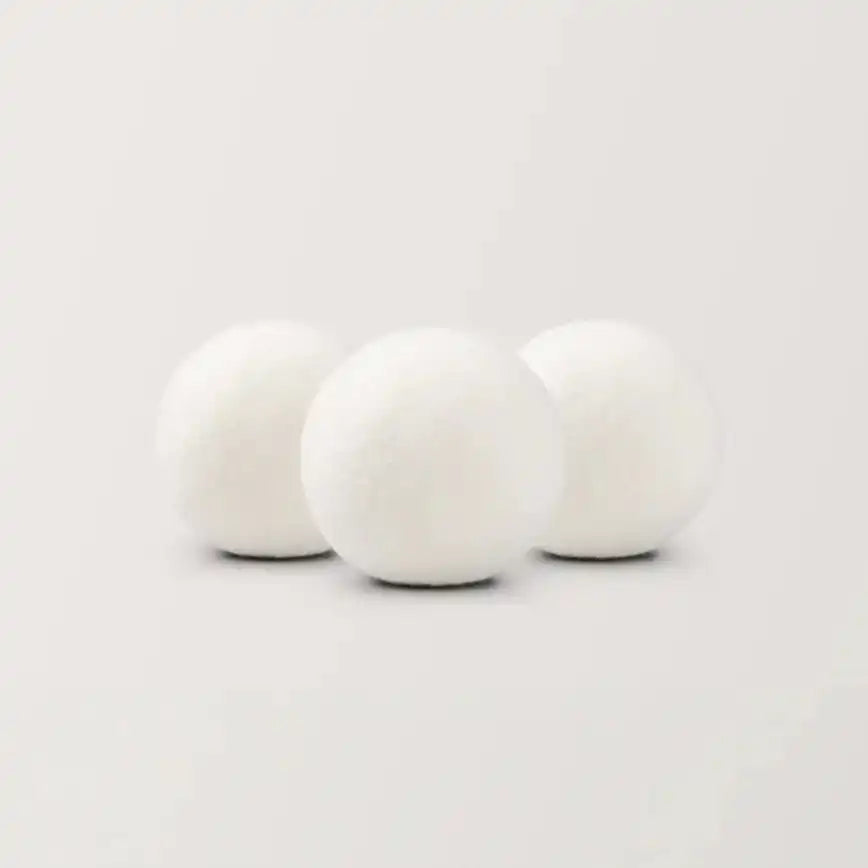 AEMBR scented wool dryer balls, three white balls on a neutral background
