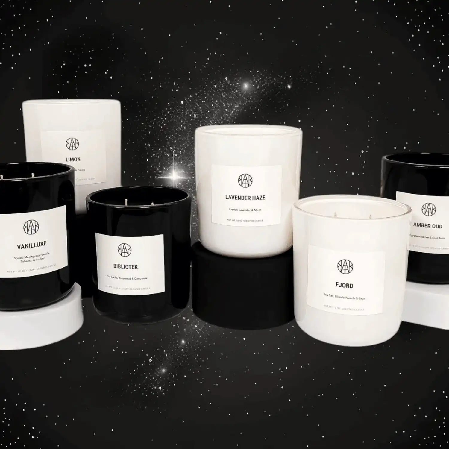 AEMBR black and white non-toxic candles displayed on stands, starry night background.