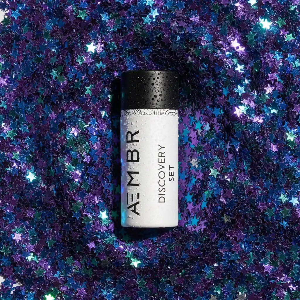AEMBR Discovery Set product on a sparkling background of blue and purple star confetti