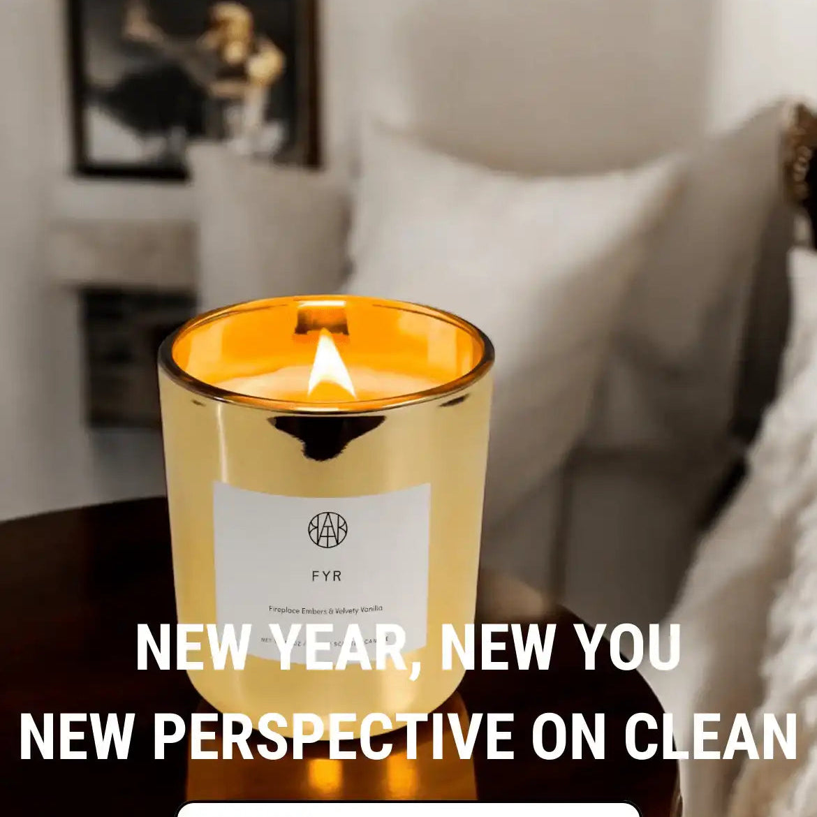 AEMBR gold candle burning on a table in cozy room, promoting non-toxic clean candles.