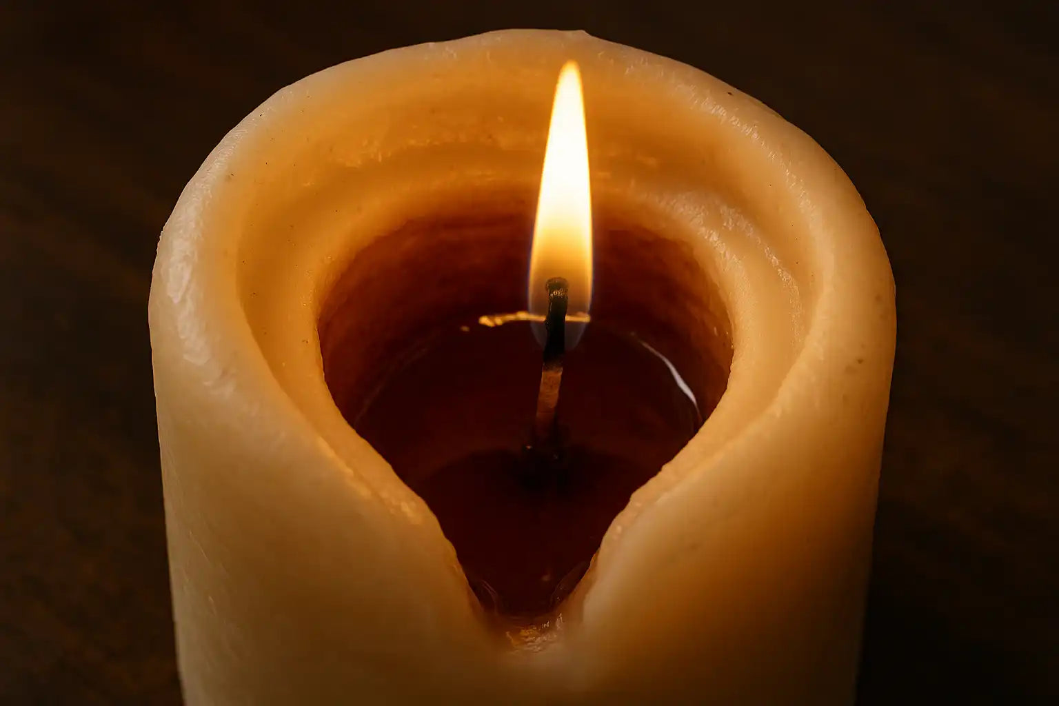 AEMBR non-toxic candle tunneling with burning wick on dark background