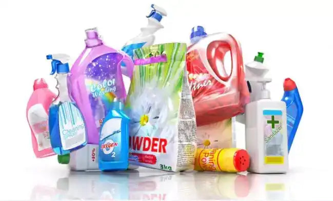 Assorted colorful detergent and cleaning product bottles grouped on a white surface