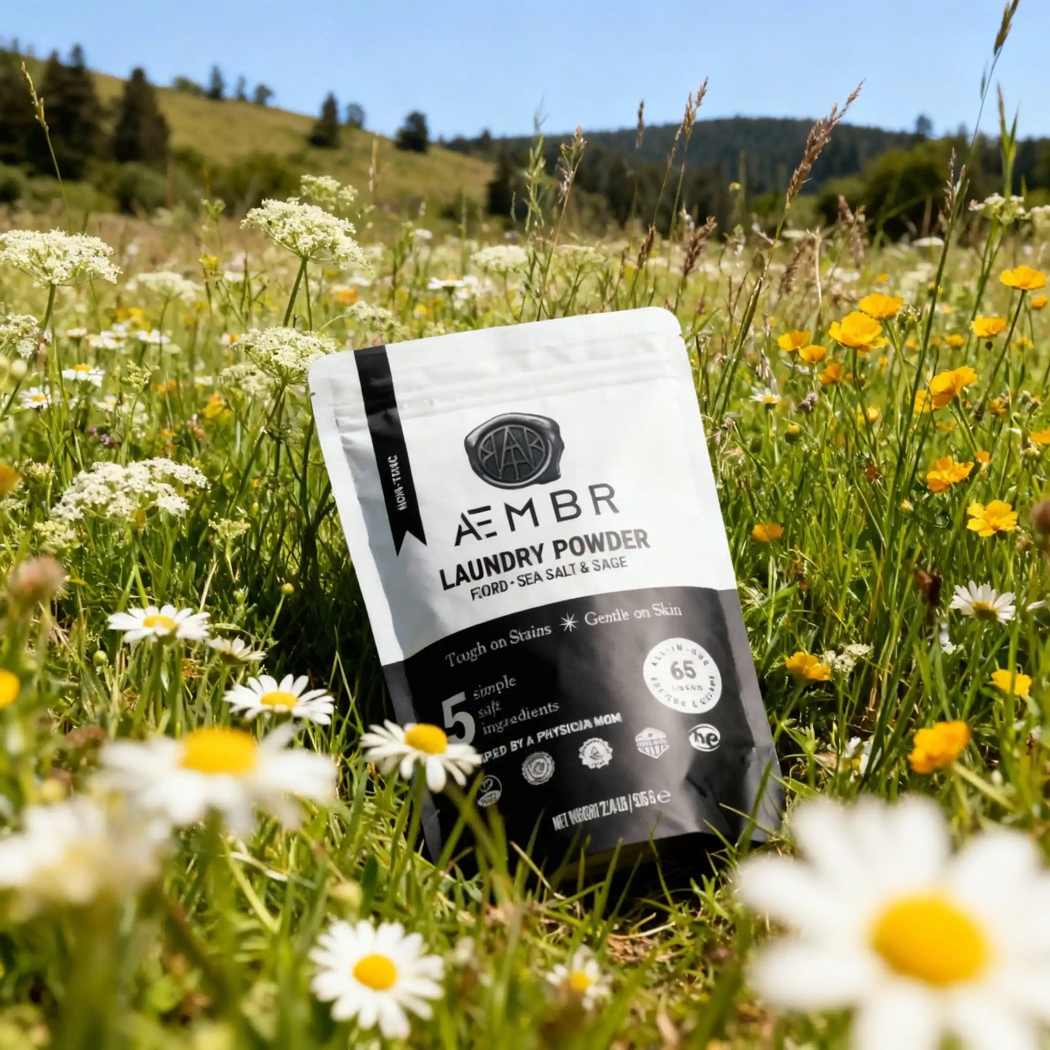 AEMBR laundry powder bag in a wildflower field, non-toxic detergent, eco-friendly home care.