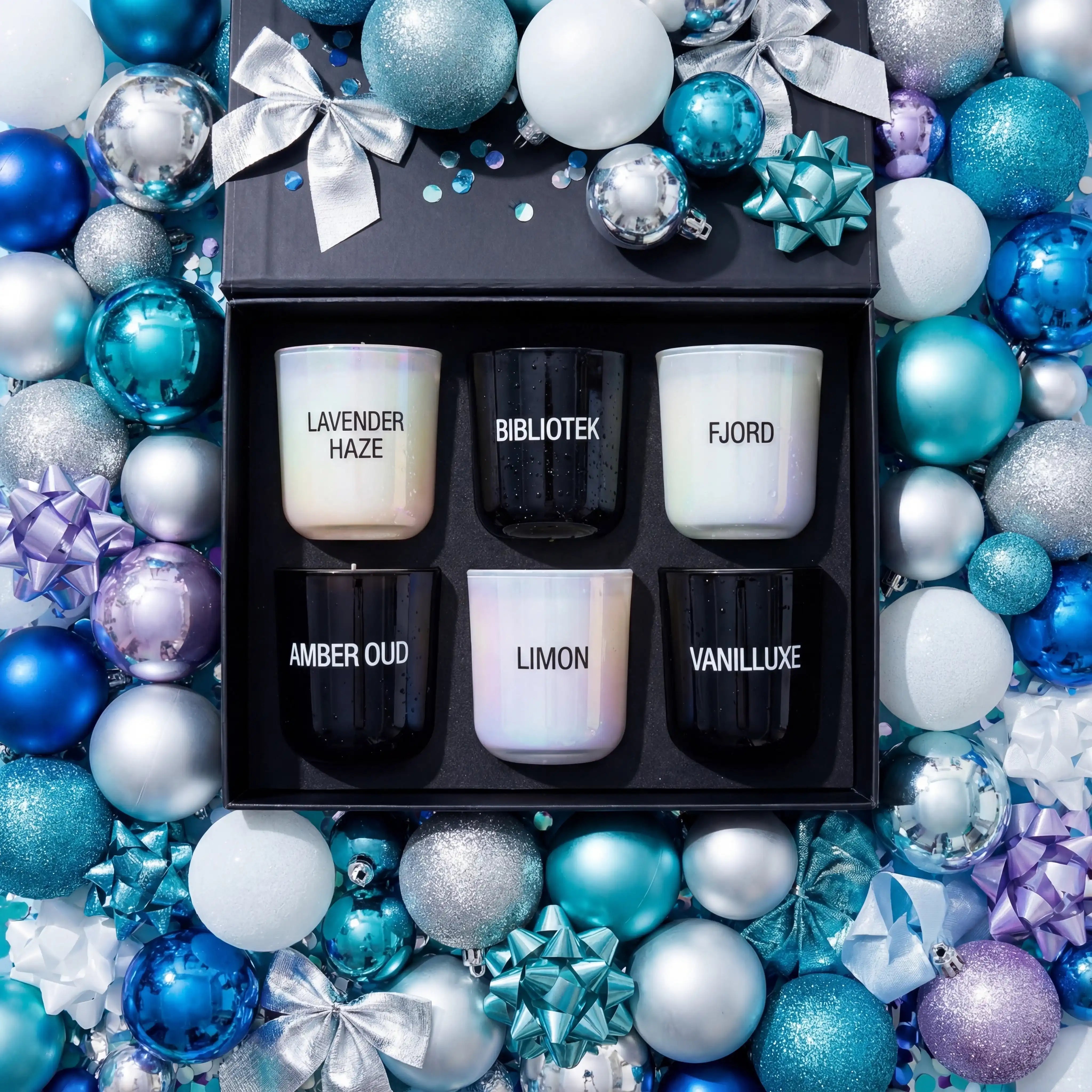 AEMBR scented candle set gift box with six candles, surrounded by blue and silver holiday ornaments.