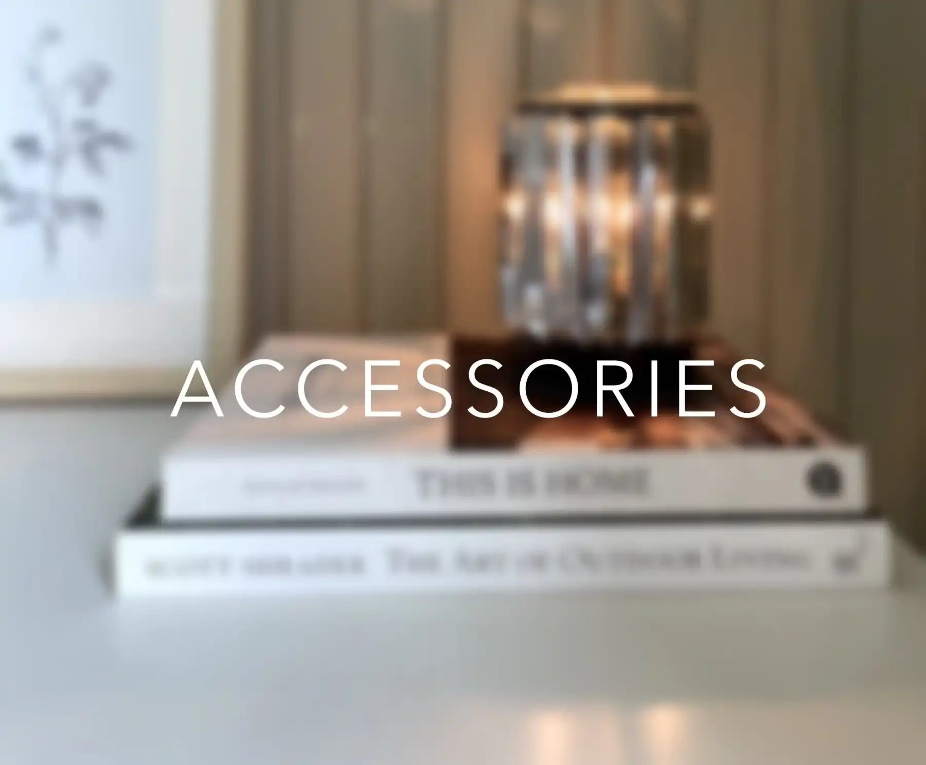 Stack of home decor books with a decorative candle holder and 'ACCESSORIES' text overlay