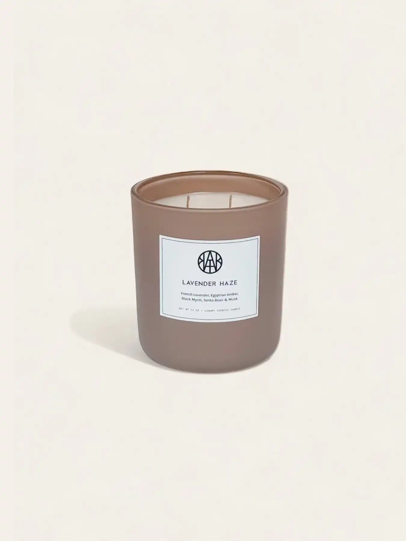Lavender Haze non-toxic scented candle by AEMBR in a matte mauve glass jar on a light background.