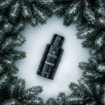 ALKYMIST Fraser Fir spray bottle on snow, surrounded by pine branches, non-toxic home fragrance