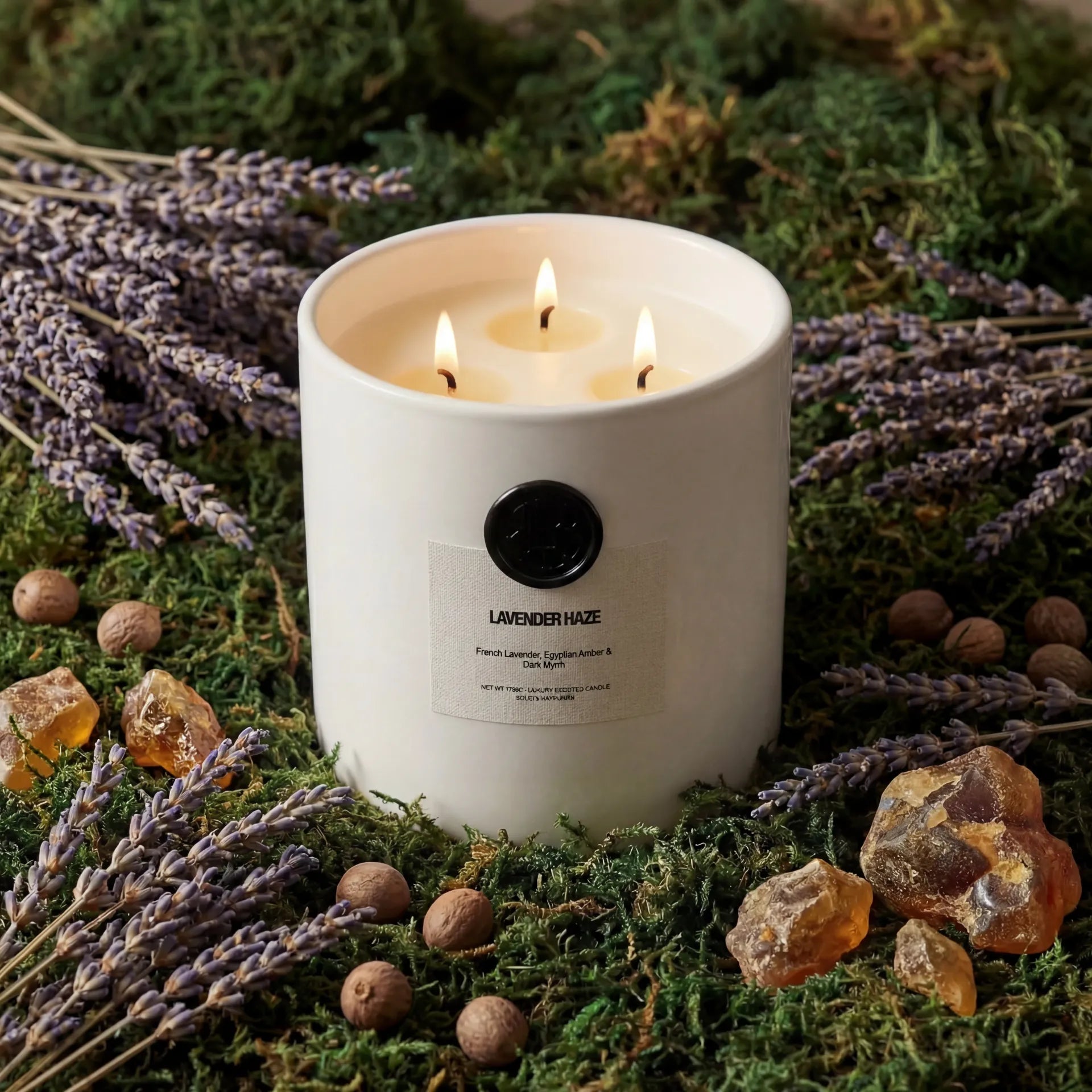 AEMBR The Viking Lavender Haze candle with a sleek glass jar and lavender-colored wax, emitting a calming fragrance.