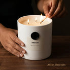 AEMBR The Viking Amber Oud candle with a sleek black container and warm amber-colored wax, ideal for cozy home decor.