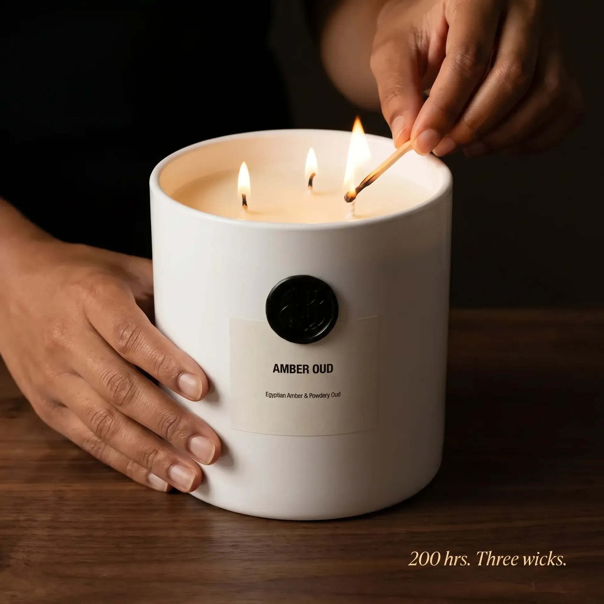 AEMBR The Viking Amber Oud candle with a sleek black container and warm amber-colored wax, ideal for cozy home decor.