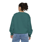 AEMBR teal green crewneck sweatshirt on a woman with blue jeans, back view, plain white background