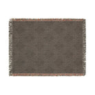 AEMBR woven throw blanket with subtle floral pattern and multicolor fringe edges on white background