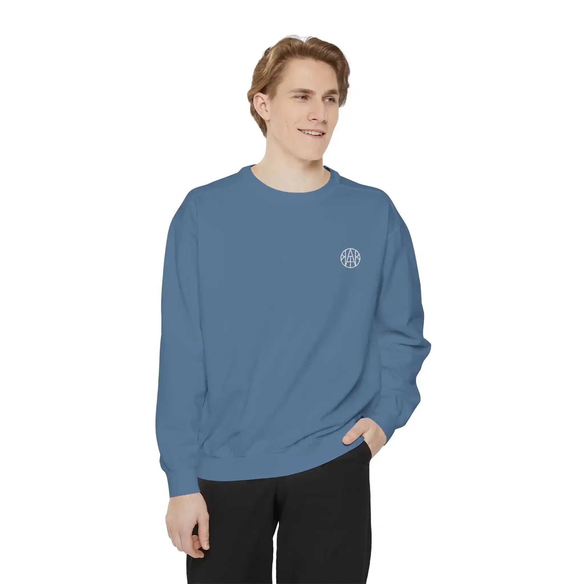 Man wearing blue AEMBR crewneck sweatshirt with logo on chest, white background