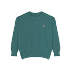 Teal crewneck sweatshirt with small white embroidered circular logo on chest