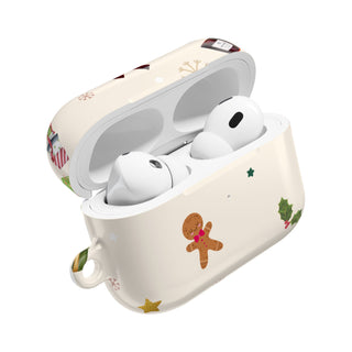 Wireless earbuds in a decorative case with Christmas-themed designs on a white background
