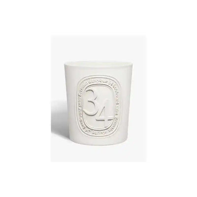 White non-toxic candle in minimalist container with embossed design, clean home decor