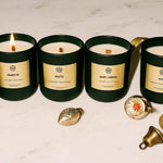 AEMBR non-toxic winter collection candles on marble with gold holiday decor