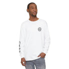 Man wearing white AEMBR long sleeve shirt with logo and branding, casual style